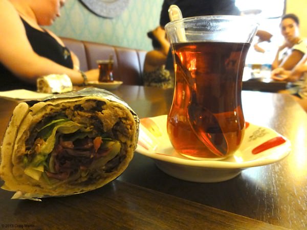 Famous kebabs, accompanied by a glass of Turkish tea.